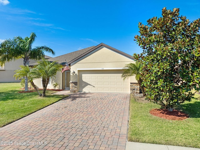 ranch-style home featuring a garage and a front lawn