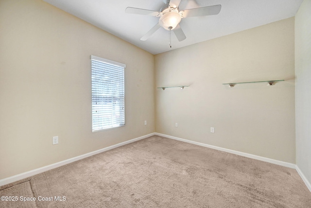 carpeted spare room with ceiling fan