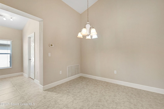 spare room featuring a notable chandelier, vaulted ceiling, and light tile patterned flooring