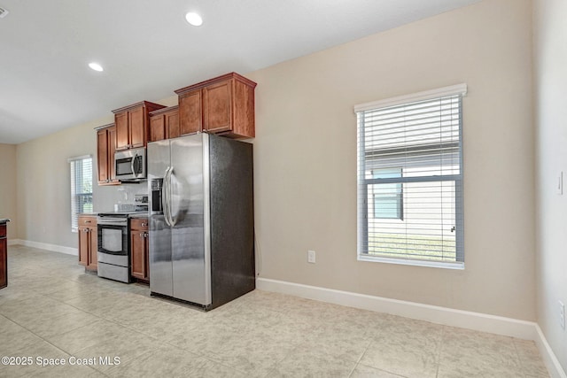 kitchen with appliances with stainless steel finishes and light tile patterned floors