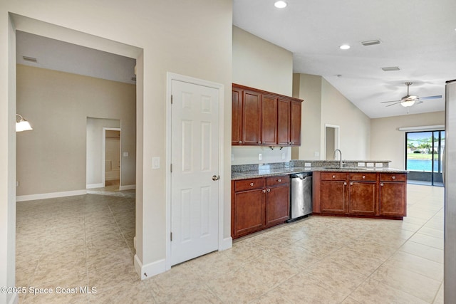 kitchen with lofted ceiling, sink, dark stone countertops, stainless steel dishwasher, and ceiling fan