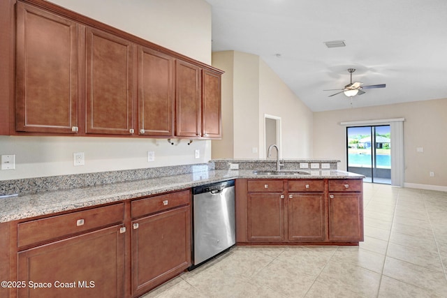 kitchen with stainless steel dishwasher, light stone countertops, and sink