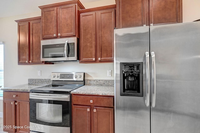 kitchen with stainless steel appliances and light stone countertops