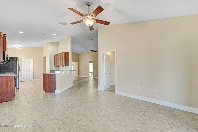 kitchen with ceiling fan, kitchen peninsula, high vaulted ceiling, and light tile patterned floors