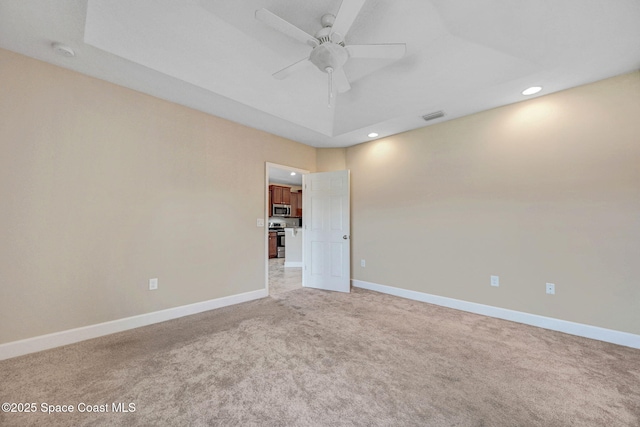 spare room with ceiling fan and carpet floors