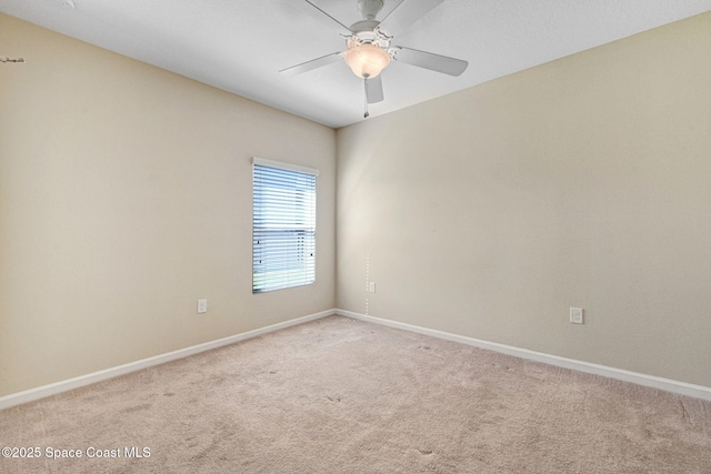 carpeted spare room with ceiling fan