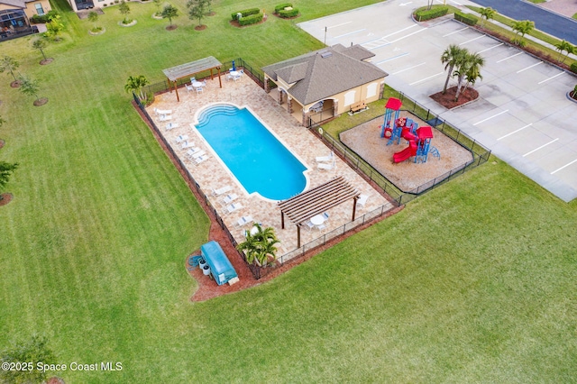 view of swimming pool with a playground