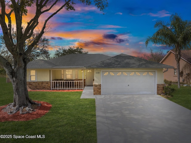 ranch-style home with a porch, a garage, and a lawn