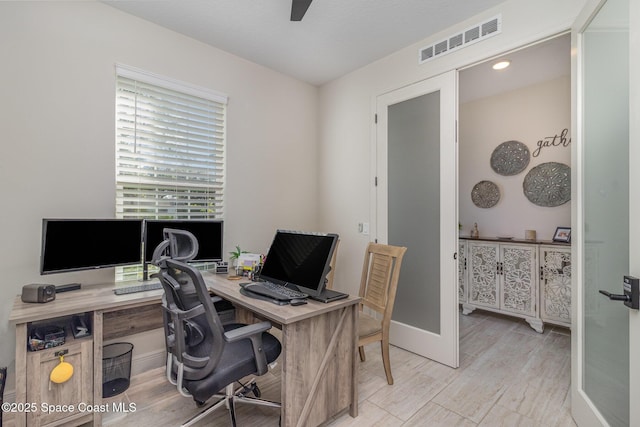 office space with ceiling fan and light wood-type flooring