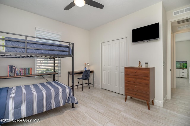 bedroom featuring light hardwood / wood-style flooring, a closet, and ceiling fan