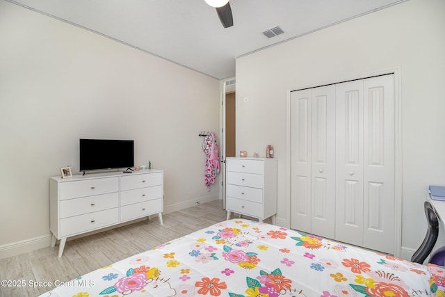 bedroom featuring ceiling fan, a closet, and light wood-type flooring