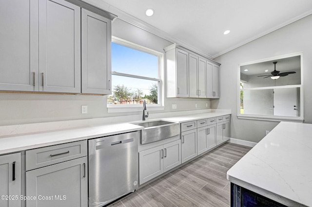 kitchen featuring gray cabinets, ornamental molding, sink, and stainless steel dishwasher