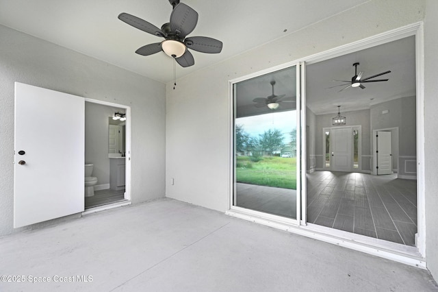 unfurnished room featuring ceiling fan and concrete flooring