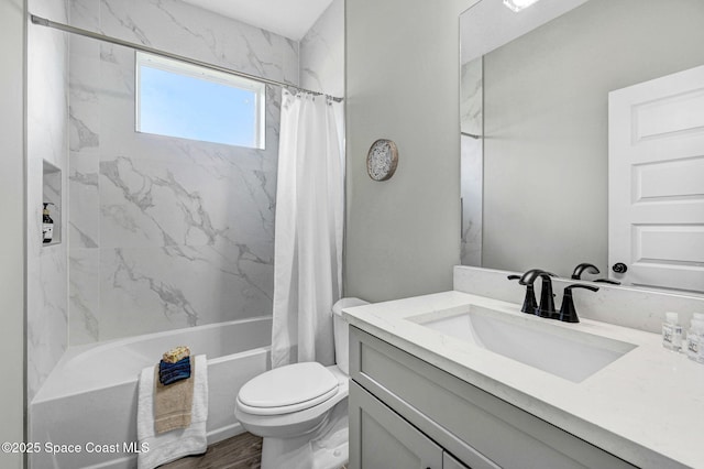 bathroom with wood finished floors, shower / bath combo with shower curtain, vanity, and toilet