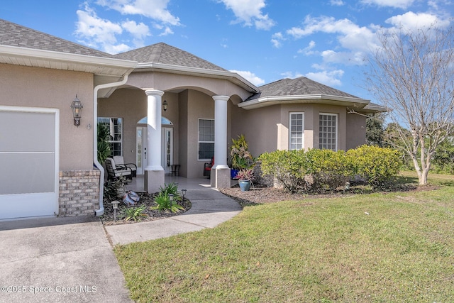 view of exterior entry with a yard