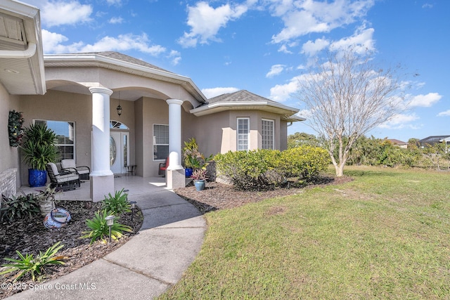 doorway to property with a yard