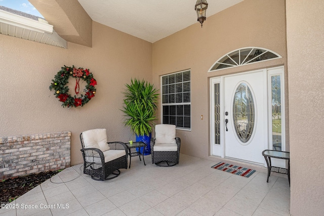 entrance to property featuring a patio area