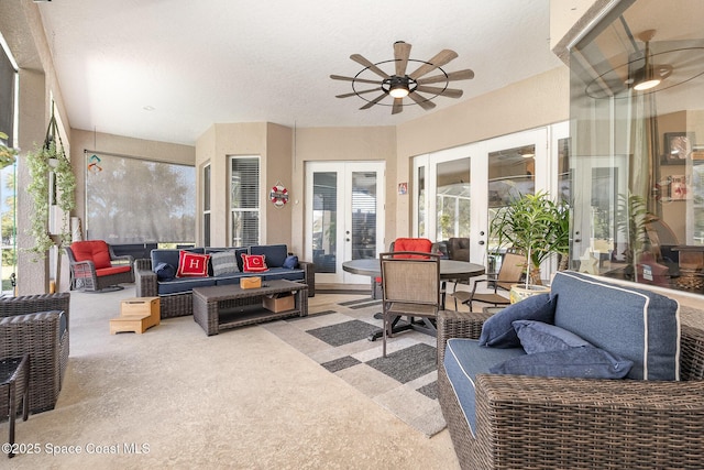 living room featuring french doors and ceiling fan