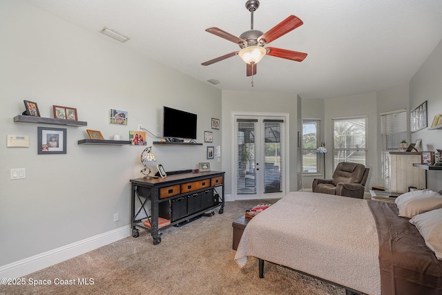 bedroom with light carpet, access to exterior, french doors, and ceiling fan