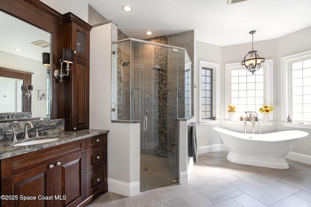 bathroom with a chandelier, vanity, separate shower and tub, and tile patterned flooring