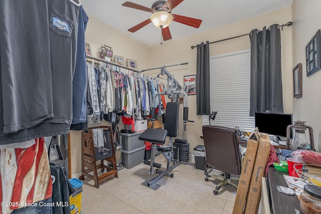 interior space with light tile patterned floors and ceiling fan