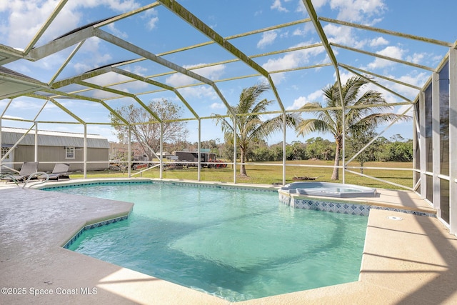 view of pool with an in ground hot tub, a yard, a lanai, and a patio