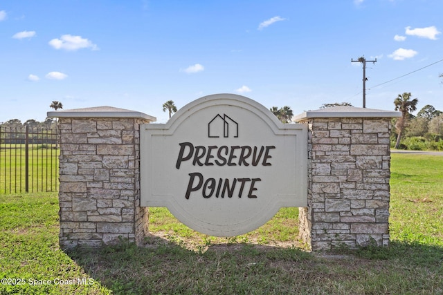 community / neighborhood sign with a lawn