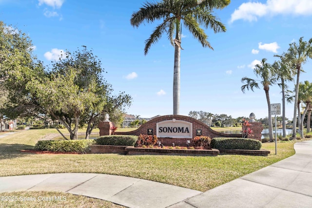 community / neighborhood sign with a lawn