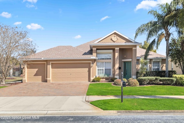 view of front of house with a garage and a front yard