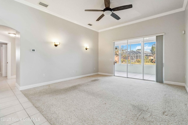 tiled spare room with ornamental molding and ceiling fan