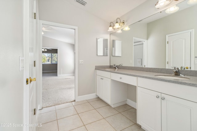 bathroom with ceiling fan, vanity, tile patterned flooring, and vaulted ceiling