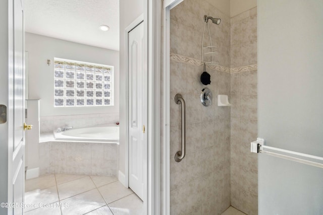 bathroom featuring tile patterned flooring, a textured ceiling, and separate shower and tub