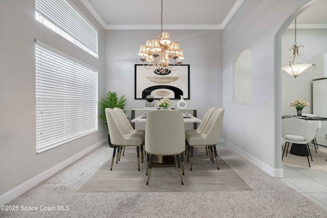 dining room with an inviting chandelier and crown molding