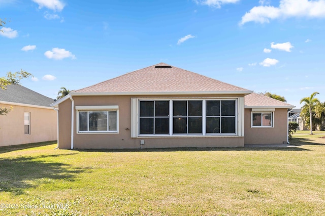 back of house with a lawn