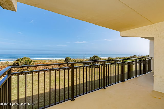 balcony featuring a beach view and a water view