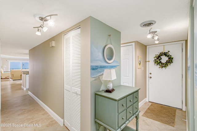 foyer entrance with light tile patterned flooring