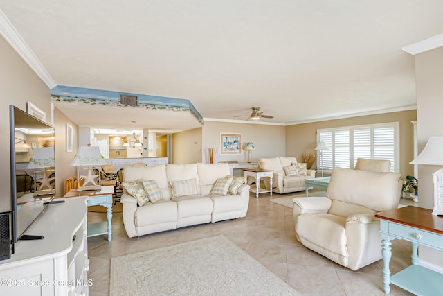 tiled living room featuring ornamental molding and ceiling fan with notable chandelier