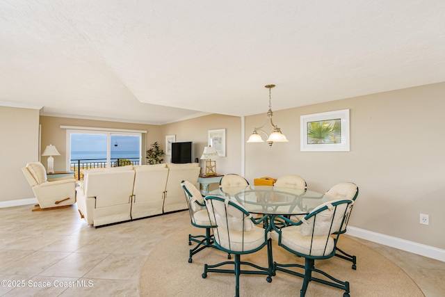 dining area featuring light tile patterned floors, a notable chandelier, baseboards, and crown molding