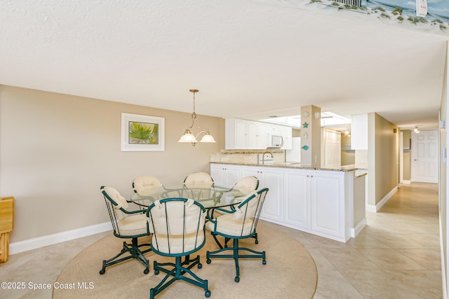 dining space with light tile patterned floors and baseboards