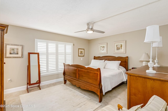 bedroom with ceiling fan and baseboards