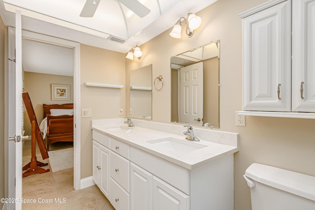 bathroom with tile patterned flooring, vanity, ceiling fan, and toilet