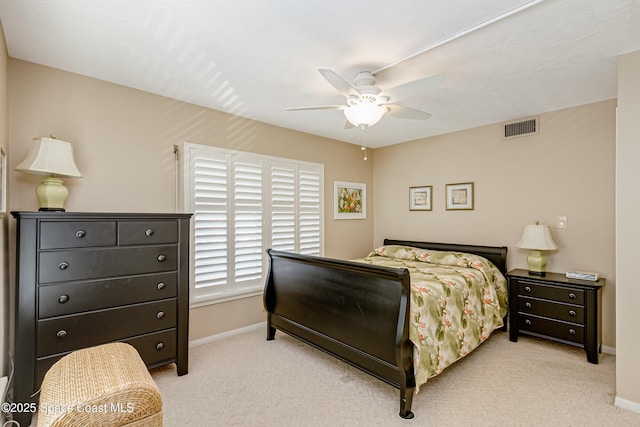 bedroom with a ceiling fan, visible vents, light carpet, and baseboards