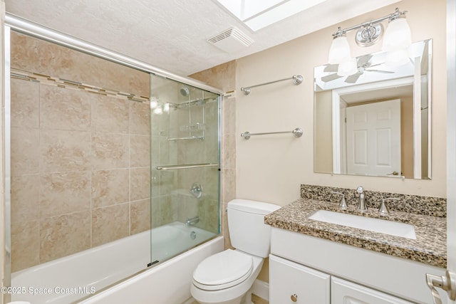 full bathroom featuring visible vents, vanity, toilet, and bath / shower combo with glass door