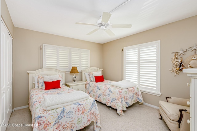 bedroom featuring a closet, carpet flooring, ceiling fan, and baseboards