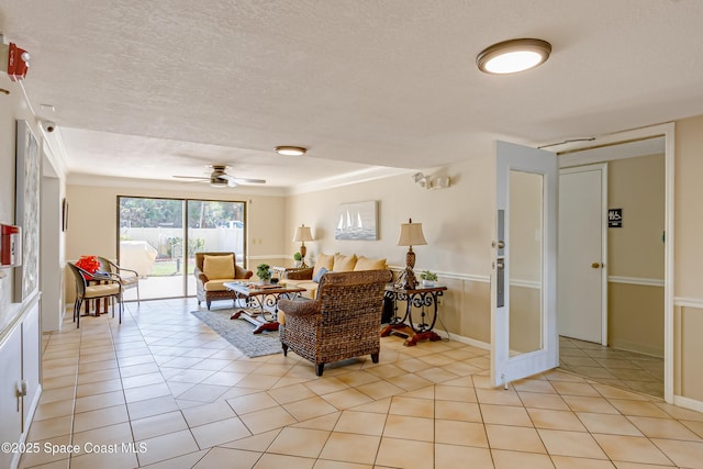 tiled living room with ceiling fan and a textured ceiling