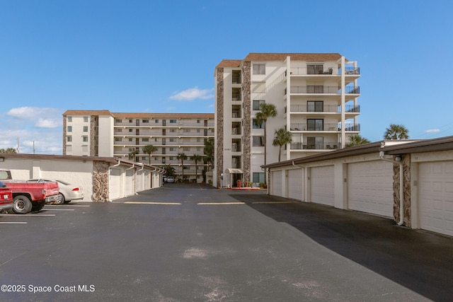 view of building exterior with community garages