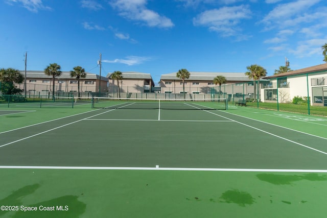 view of sport court featuring a residential view and fence