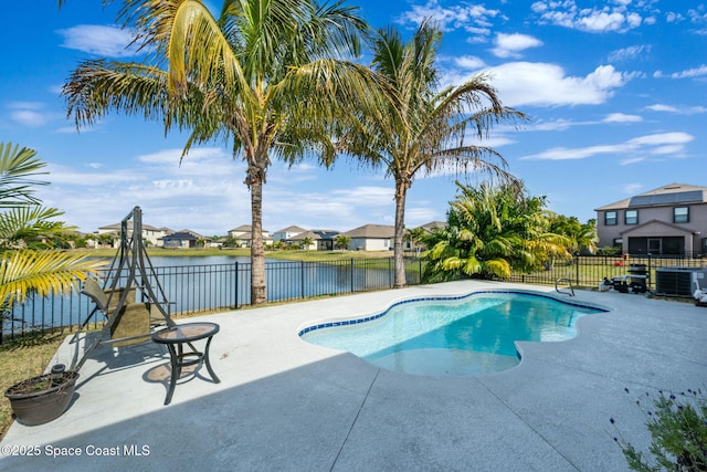 view of swimming pool featuring a patio, a water view, and central air condition unit