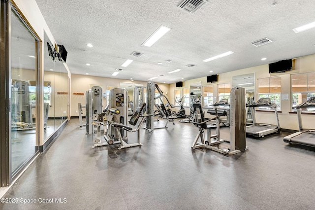 exercise room featuring a textured ceiling