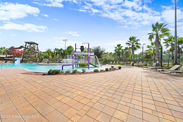 view of swimming pool with pool water feature and a water slide